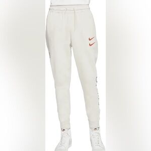 Nike Kids Cream Joggers with Red Swoosh and Blue Lettering